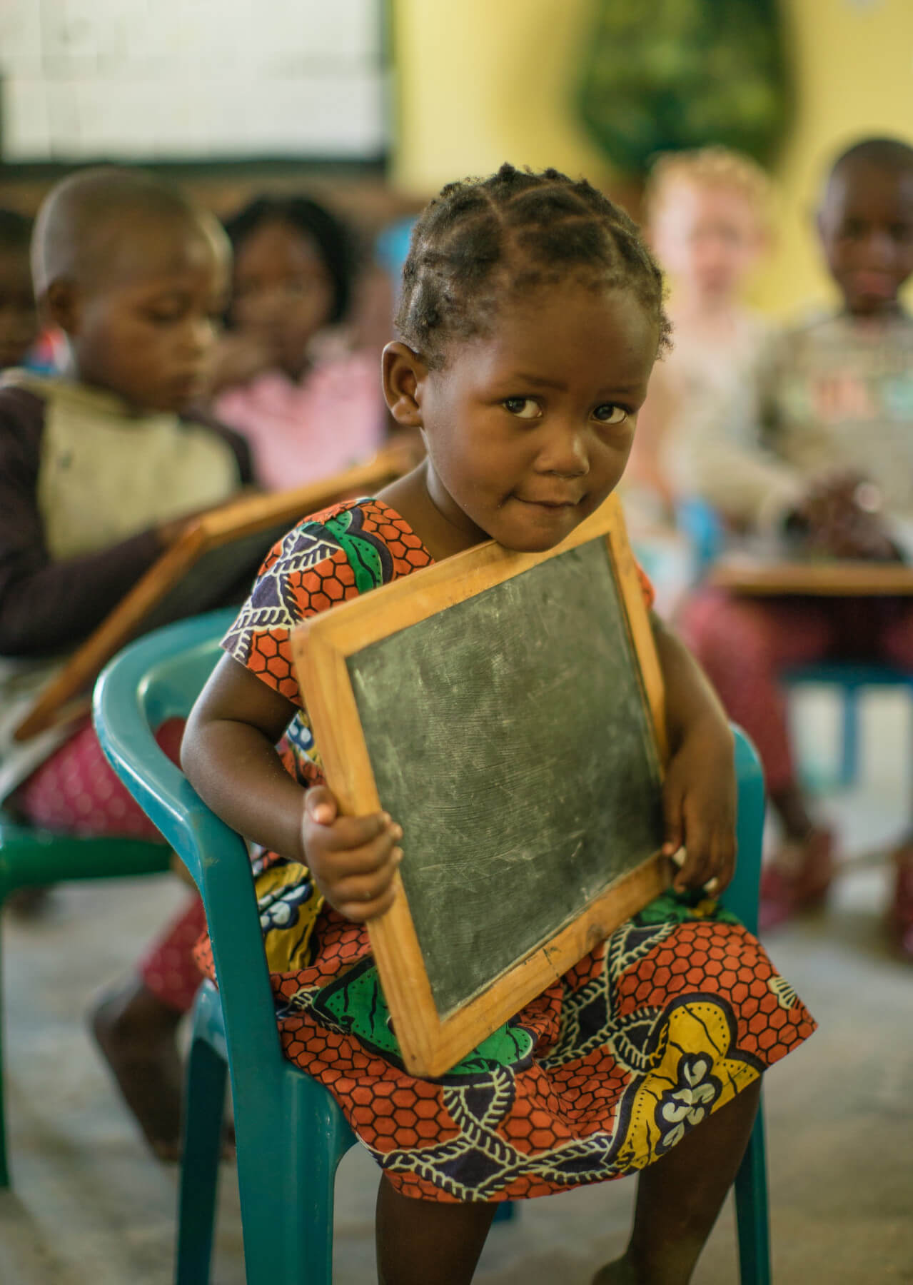 school girl holding chalkboard - Pack for a purpose
